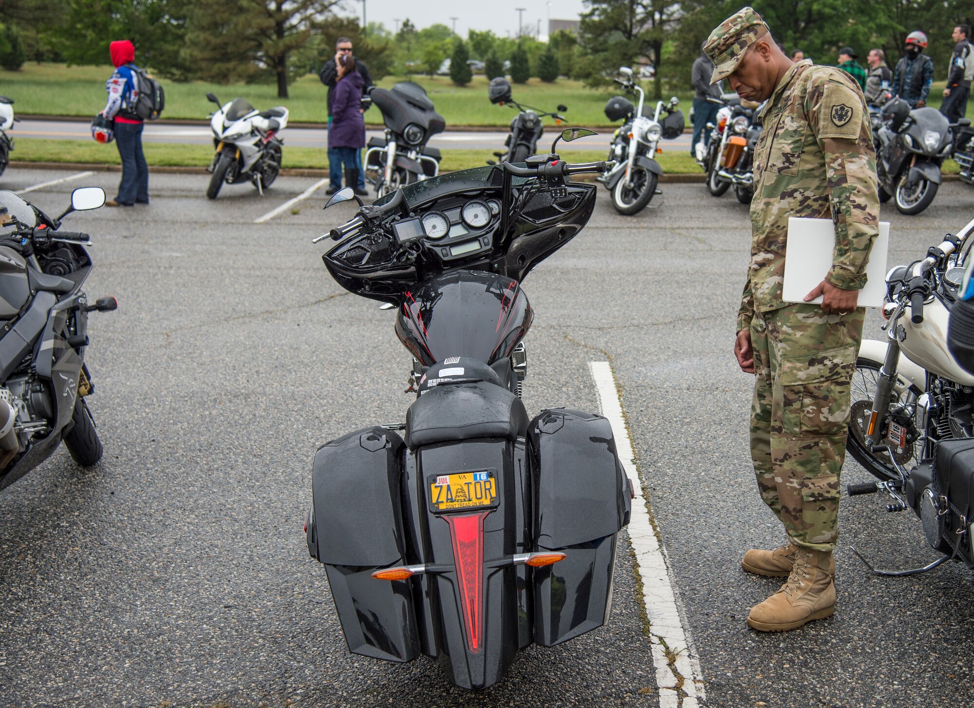 U.S. Army Col. Joseph E. Ladner, vice commander of the 633rd Air Base Wing, checks out a motorcycle during the 5th annual Standing Together Against Rape Road Rally at Langley Air Force Base, Va., April 29, 2016. The event aimed to increase awareness by standing together in an effort to eliminate sexual assault. (U.S. Air Force photo by Senior Airman Kayla Newman)