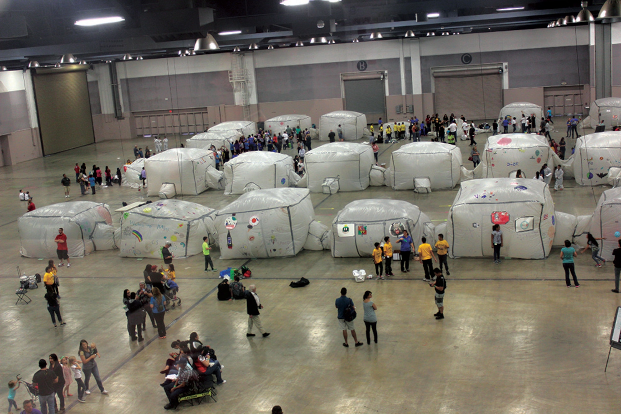 Students and chaperones bustle around in the view looking down onto two of the three Mars mission colonies from Mission Control at the Albuquerque Convention Center. (Photo by Bud Cordova)