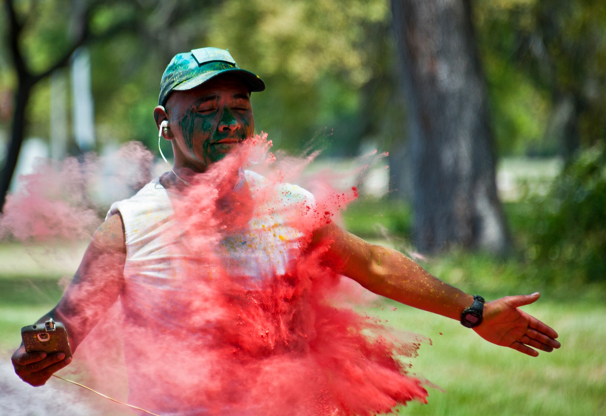 A runner sprints through a cloud of red dust during the Sexual Assault Prevention and Response Color Run at Eglin Air Force Base, Fla., April 29.  Approximately 300 runners turned out to add a little color to their afternoon workout.  (U.S. Air Force photo/Samuel King Jr.)