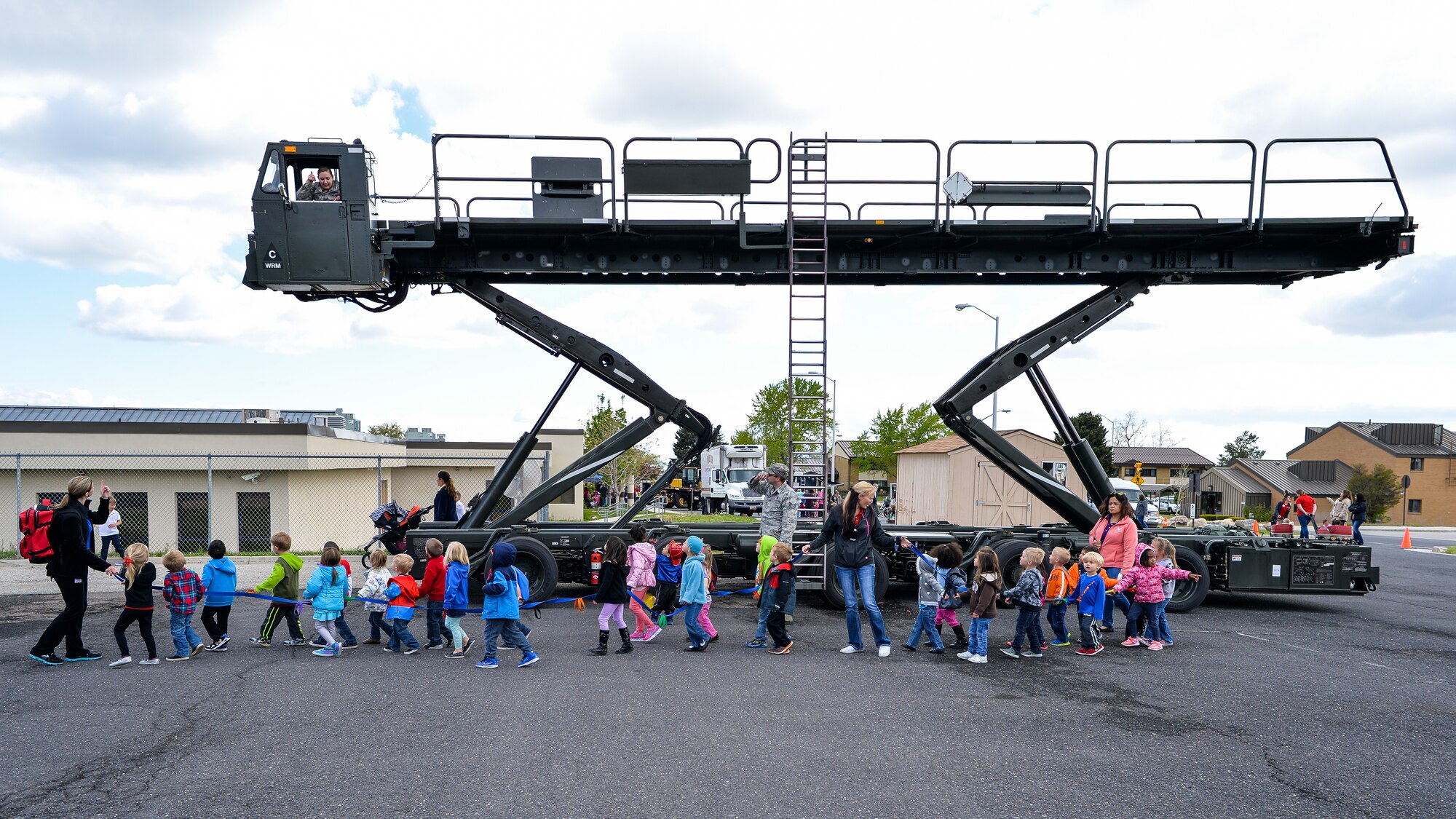 A group of children walk past a Tunner 60K Loader during the Wheels of Wonder Event, April 29, 2016, Hill Air Force Base, Utah. The annual event features a variety of wheeled vehicles for children and adults to explore. (U.S. Air Force photo by R. Nial Bradshaw)