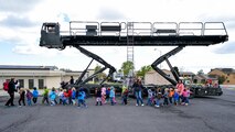 A group of children walk past a Tunner 60K Loader during the Wheels of Wonder Event, April 29, 2016, Hill Air Force Base, Utah. The annual event features a variety of wheeled vehicles for children and adults to explore. (U.S. Air Force photo by R. Nial Bradshaw)