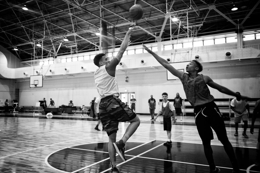 A 3-on-3 basketball tournament participant takes a jump shot at Yokota Air Base, Japan, April 29, 2016. The 374th Airlift Wing sexual assault prevention and response team provides direct interpersonal support, crisis intervention and informed decisions regarding restricted and unrestricted reporting. (U.S. Air Force photo by Senior Airman Delano Scott/Released)