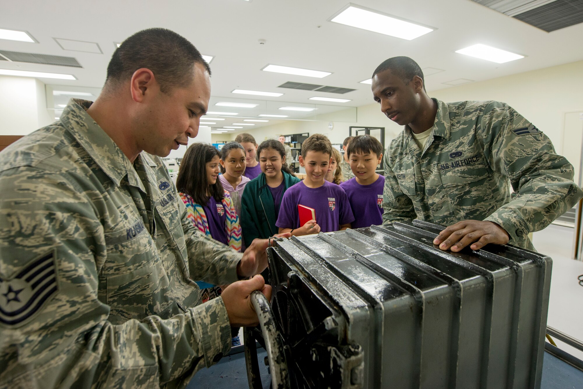 U.S. Air Force Tech. Sgt. William Kunsman, 18th Component Maintenance Squadron physical dimensions section supervisor, and U.S. Air Force Airman 1st Class Jarrod Keith, 18th CMS test measurement and diagnostic equipment technician, demonstrate the effects of a vacuum on marshmallows for Okinawa Christian School International 5th grade students April 28, 2016, at Kadena Air Base, Japan. In a vacuum the air is sucked out of the marshmallows causing them to expand and when air is restored in the chamber the marshmallows contracted. The 18th CMS is able to test equipment in a vacuum to ensure it can function in specific environments. (U.S. Air Force photo by Senior Airman Omari Bernard)