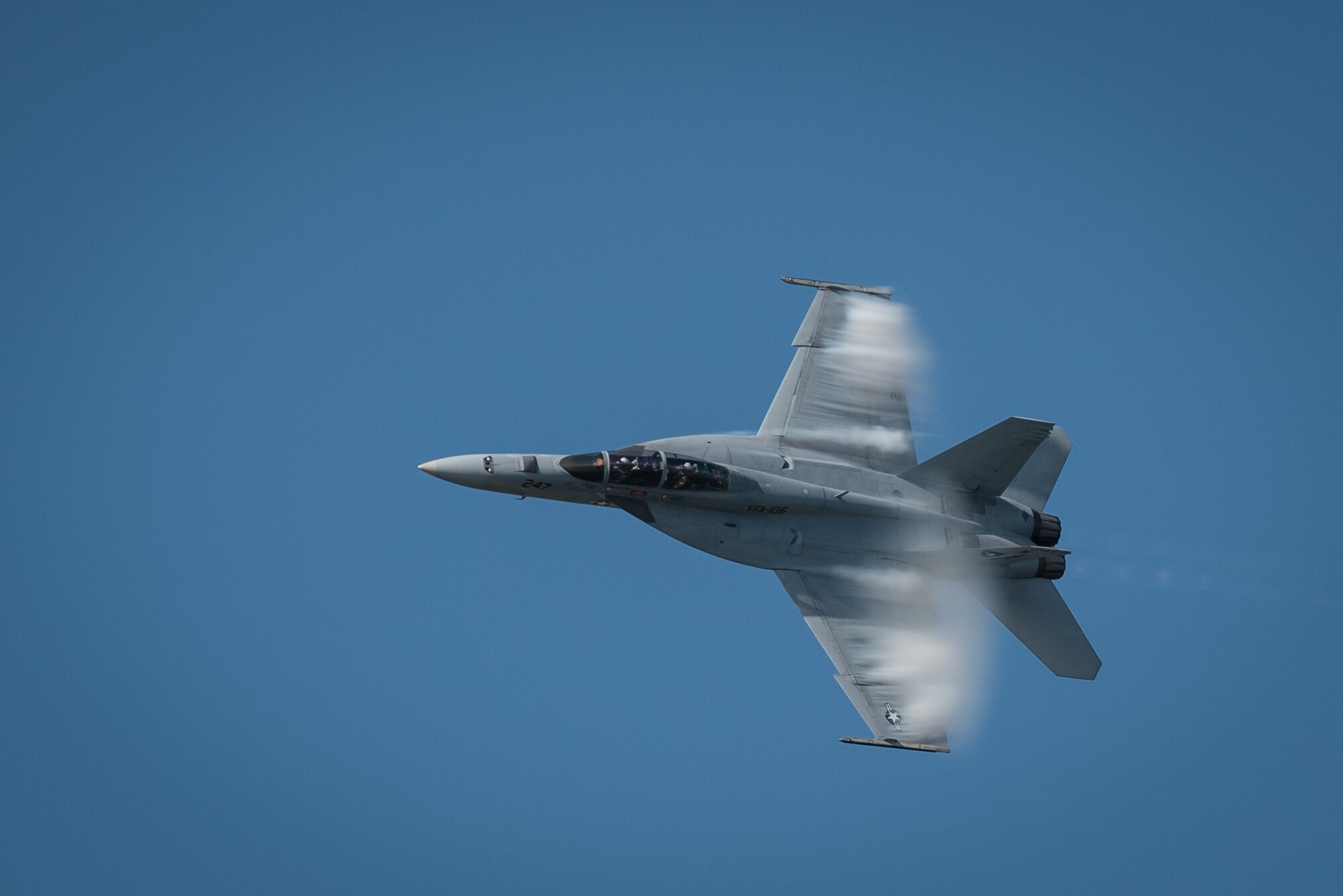 A vapor cloud forms around the fuselage of a U.S. Navy F/A-18 Super Hornet during the fighter jet’s demonstration in the Thunder Over Louisville air show over downtown Louisville, Ky., April 23, 2016. Vapor clouds form because air passing over the aircraft at high speeds begins to condense as the temperature drops below the dew point. (U.S. Air National Guard photo by Maj. Dale Greer)