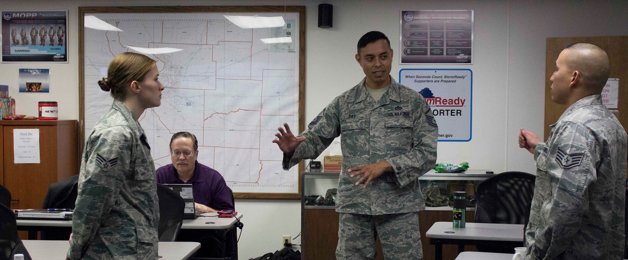 Master Sgt. Aron Day, NexGen system integration manager for the Air Force Civil Engineer Center Operations Maintenance Division, discusses a shop support business process with Scott Air Force Base, Illinois, personnel during a break at a March 2016 training event. The visit was aimed at informing operations flight personnel of the organization and business process changes required to prepare for the NexGenIT initial operating capability. (Air Force Photo/Susan Lawson/Released)