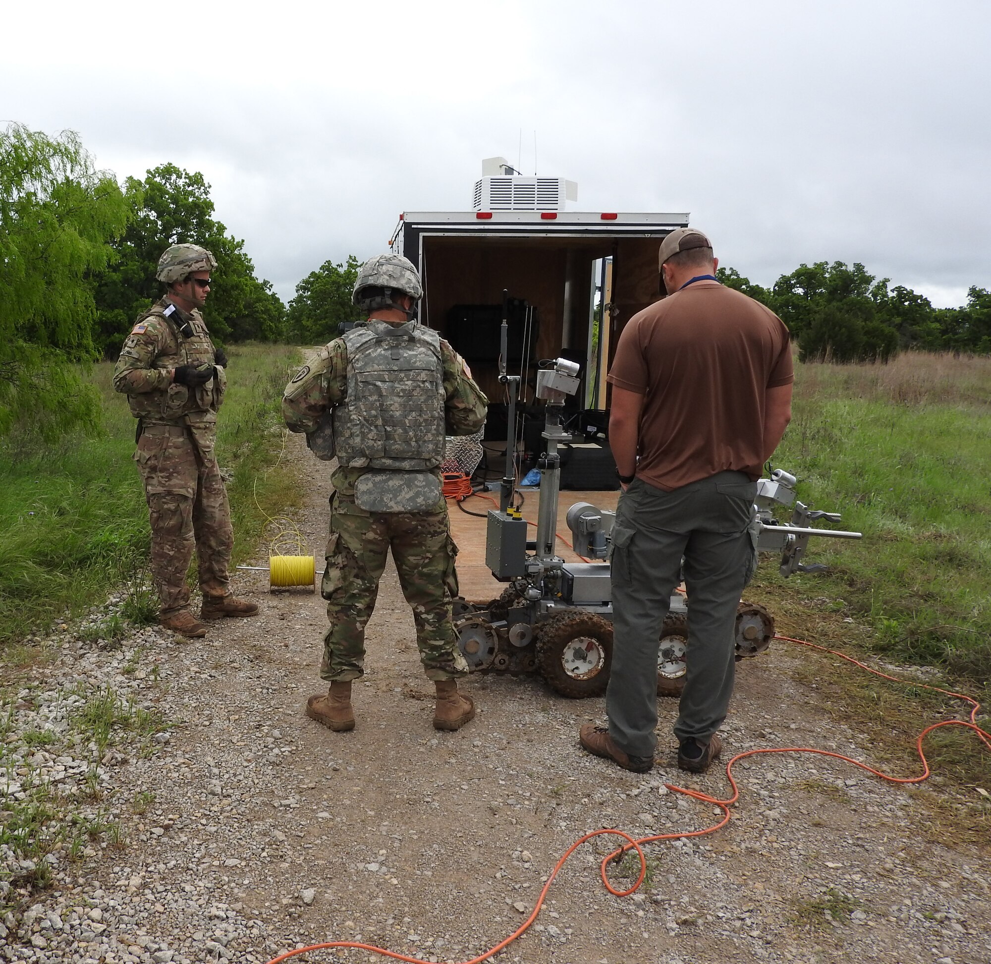 Raven’s Challenge X participants examine a robot during a scenario involving a downed unarmed vehicle with an incendiary explosive device at Fort Wolters, Texas, April 20, 2016.  (U.S. Air Force Photo/Steve Warns/Released)