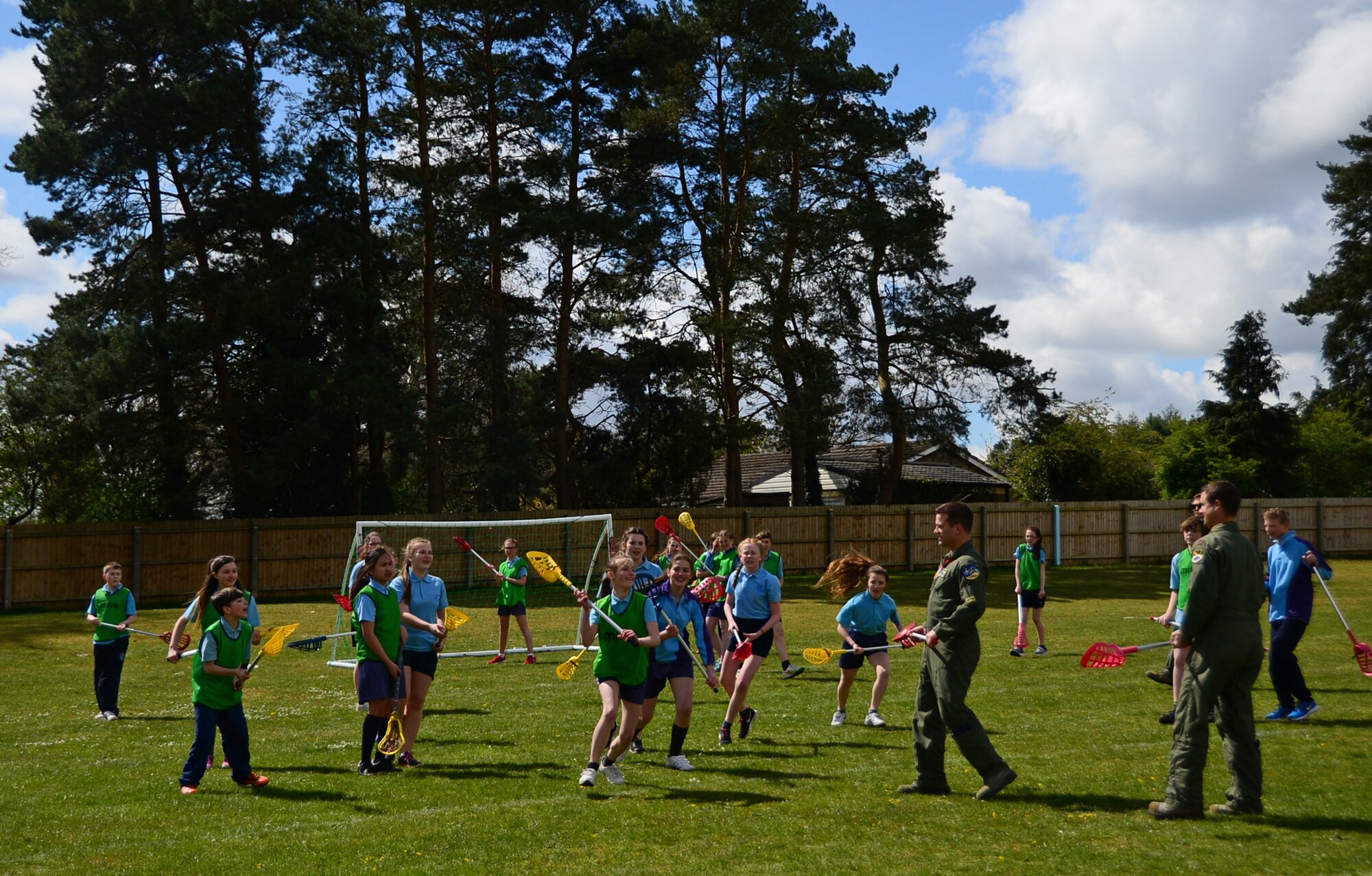 Airmen from the 95th Fighter Squadron at Tyndall Air Force Base, Fla., participate in a game of lacrosse with British students at IES Breckland in Brandon, England, April 26. The Airmen are temporarily deployed to Royal Air Force Lakenheath, England, to conduct air training exercises with U.S. and RAF personnel. During their stay, they visited the school to educate students about the U.S. Air Force, aviation, and fitness, and later participated in a question and answer forum to help the students gain a better understanding about the military lifestyle. (U.S. Air Force photo/Senior Airman Erin Trower)