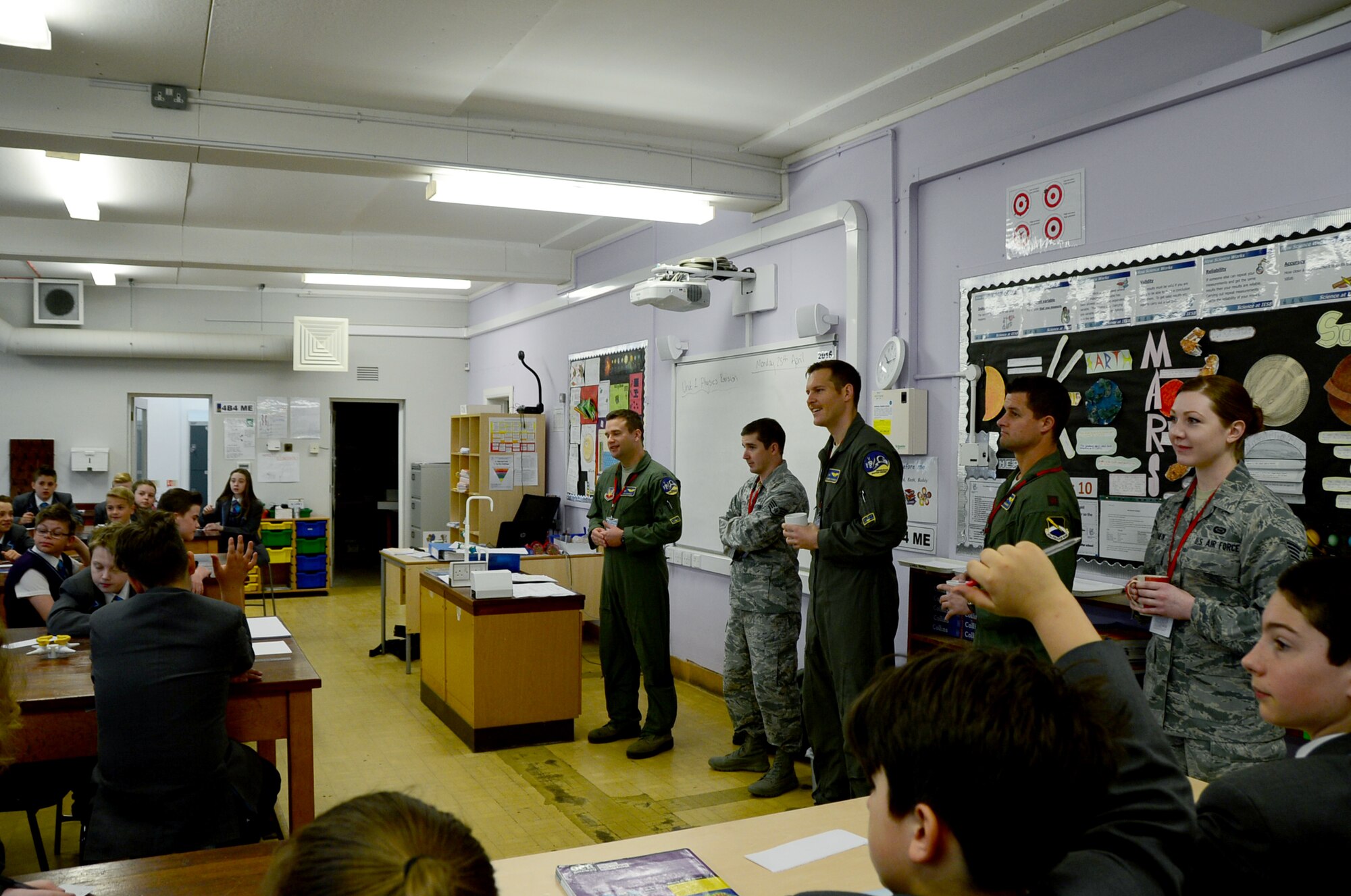 Airmen assigned to the 95th Fighter Squadron at Tyndall Air Force Base, Fla., speak to students in a science class at IES Breckland in Brandon, England, April 26. The temporarily deployed Airmen visited the school to educate students about the U.S. Air Force, aviation, and fitness, and later participated in a question and answer forum to help the students gain a better understanding about the military lifestyle. (U.S. Air Force photo/Senior Airman Erin Trower) 