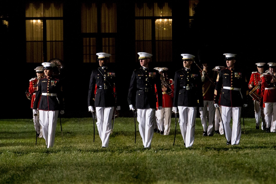 The parade staff conducts eyes right during the Friends and Family Evening Parade at Marine Barracks WASHINGTON, D.C., April 29, 2016. The guest of honor for the evening was Gen. Robert Neller, commandant of the Marine Corps, and the hosting official was Col. Benjamin T. Watson, commanding officer, MBW.