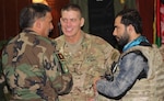 U.S. Army Maj. Gen. Paul Ostrowski, deputy commander of Combined Security Transition Command-Afghanistan, discusses training efforts underway for the Afghan National Defense and Security Forces explosive ordnance disposal technicians with Afghan National Army Col. Muhammad, commander, National Engineering Brigade. (U.S. military photo by Lt. Charity Edgar)