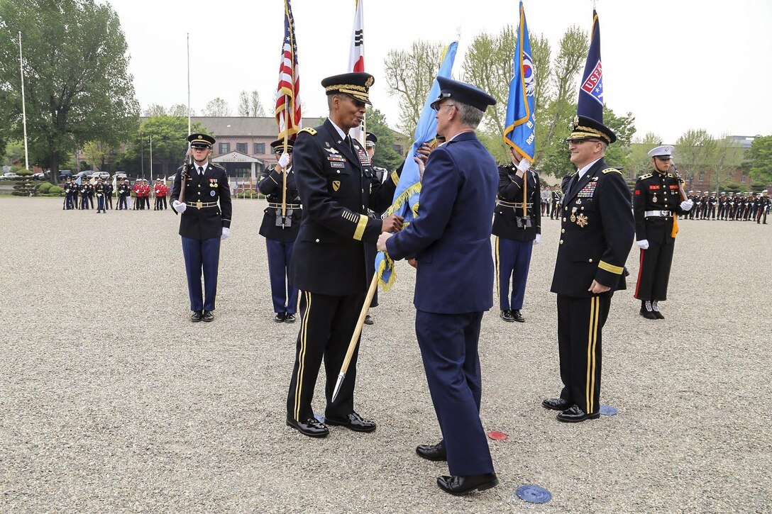 Army Gen. Vincent K. Brooks takes the U.S. Forces Korea colors from Air Force Gen. Paul J. Selva, vice chairman of the Joint Chiefs of Staff, during a change-of-command ceremony in Yongsan Garrison in South Korea, April 30, 2016. During the ceremony, Brooks took command of United Nations Command, Combined Force Command and U.S. Forces Korea. Army photo by Sgt. Russell Youmans