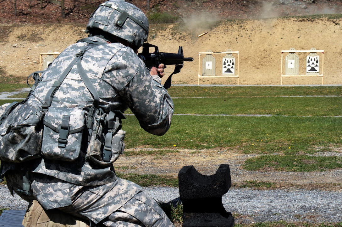 Army Spc. Corey Berke fires an M16 rifle from the kneeling position during the weapons qualification event of the Best Warrior Competition at Camp Smith Training Site near Peekskill, N.Y., April 21, 2016. Berke is a network systems operator assigned to the New York Army National Guard. New York National Guard photo by Army Sgt. Michael Davis
