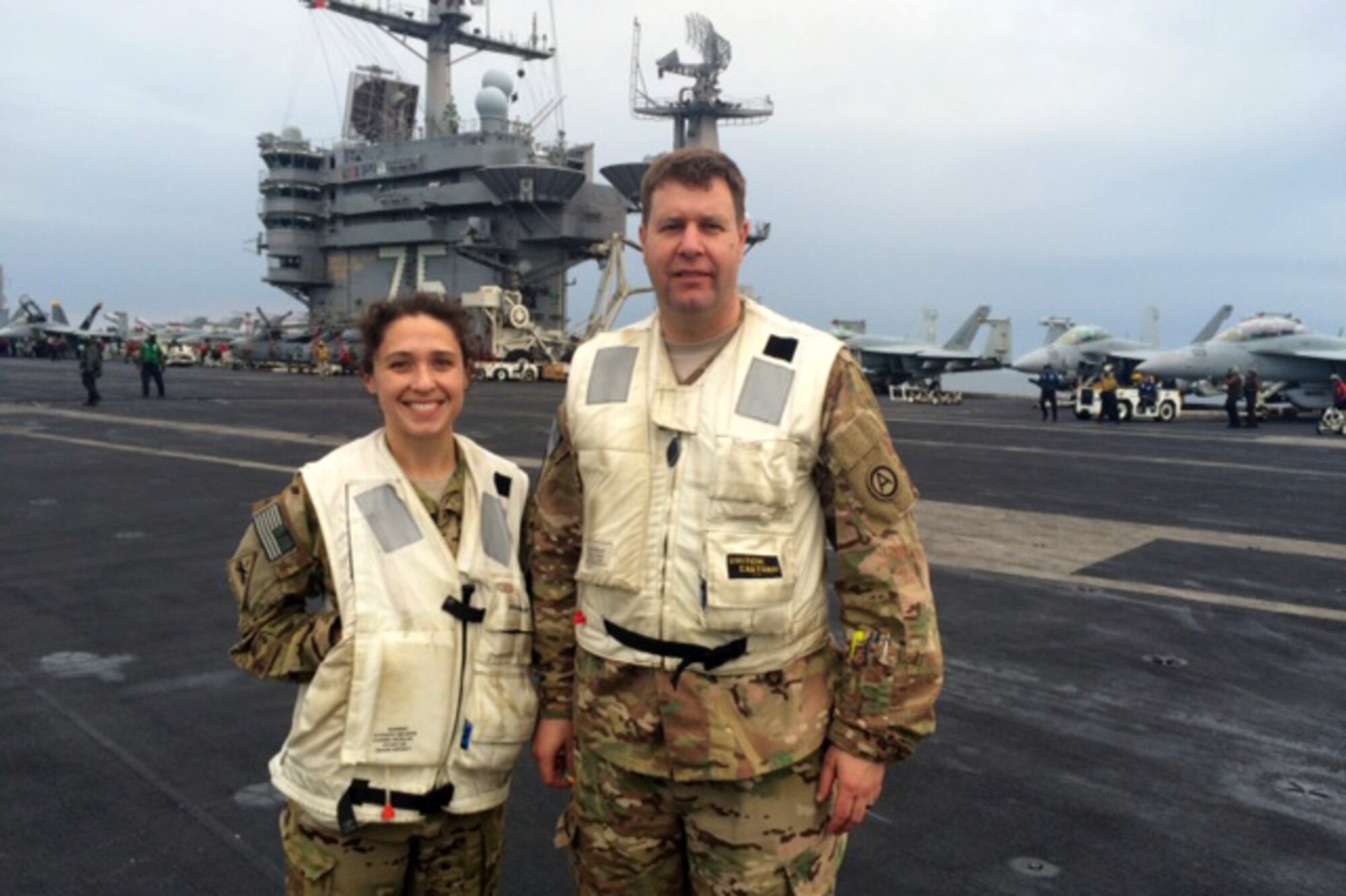 Col. Samuel Saine, commander 4th Battlefield Coordination Detachment, poses with Capt. Felicity Sparks, a 4th BCD Ground Liaison Officer, aboard the USS Harry S Truman March 14, 2016. The 4th BCD utilizes GLOs to act as a bridge between the air component and the ground and sea components. 