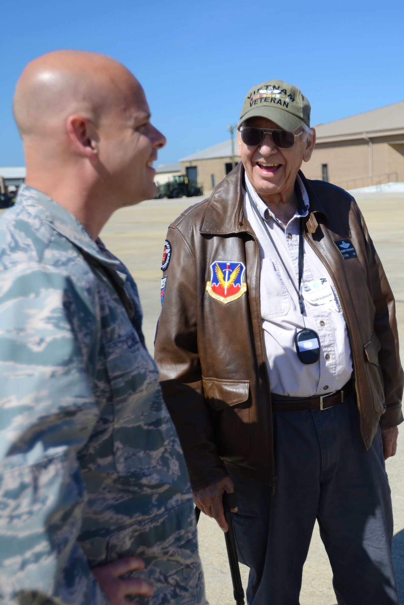 Retired U.S. Air Force Lt. Col. Joseph Kuhlmann speaks with a member of Team Shaw during a General Aviation Fly In event at Shaw Air Force Base, S.C., April 29, 2016. The event included the chance to fly an F-16CM Fighting Falcon simulator, a tour of Radar Approach Control, and an up-close look at an F-16. (U.S. Air Force photo by Airman 1st Class Kelsey Tucker)