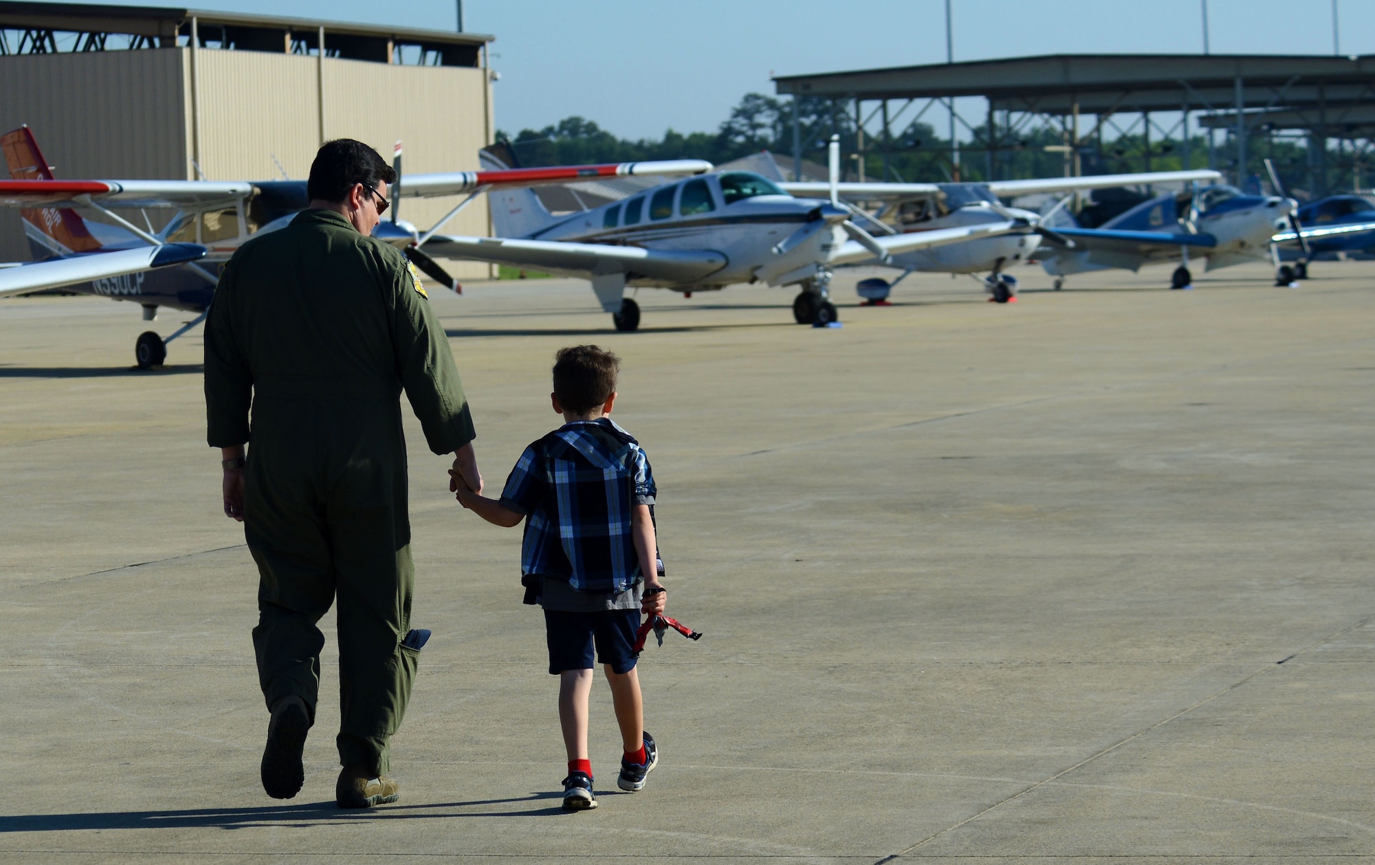 U.S. Air Force Lt. Col. Kris Padilla, 20th Fighter Wing chief of safety, and his son look at aircraft on the flight line at Shaw Air Force Base, S.C., April 29, 2016. Seventy-nine civilian aircraft and more than 100 people participated in Shaw’s first General Aviation Fly-In since 1977. (U.S. Air Force photo by Airman 1st Class Kelsey Tucker)