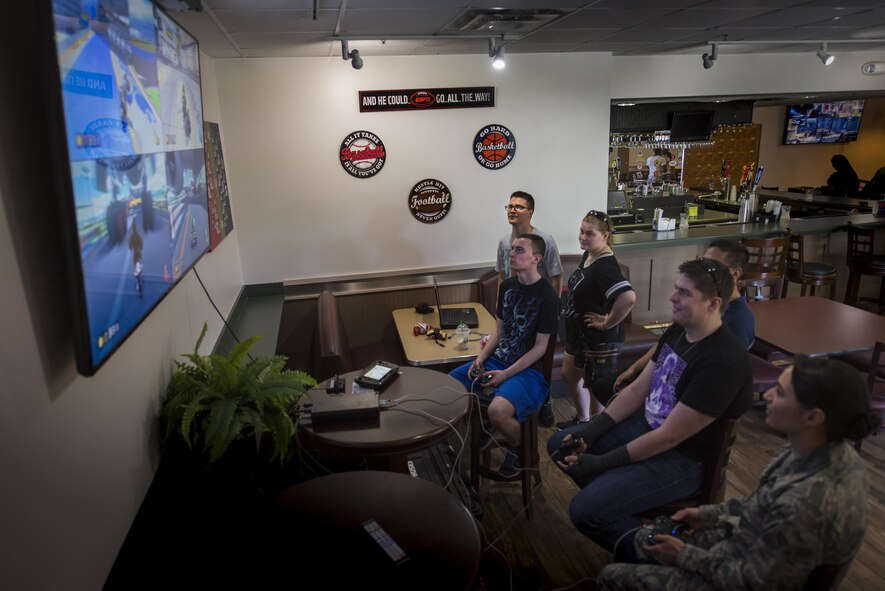 U.S. Air Force Airmen play multiplayer video games during Comprehensive Airmen Fitness day, April 29, 2016, at Moody Air Force Base, Ga. The day emphasized the social pillar with individual morning events within units before meeting for a commander’s call, lunch and social time. (U.S. Air Force photo by Airman Daniel Snider/Released)