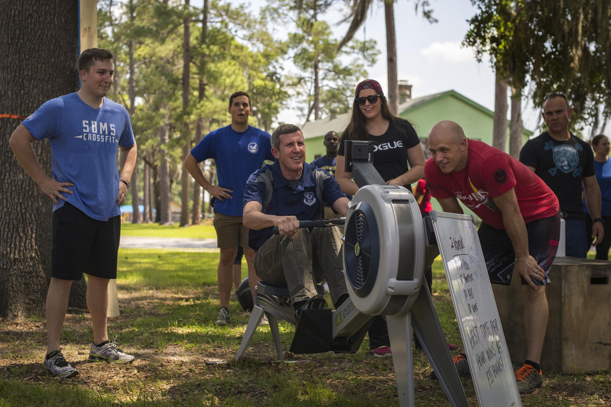 U.S. Air Force Airmen watch as Col. Thomas Kunkel, 23d Wing commander, sets a new high score on the rowing machine during Comprehensive Airmen Fitness day, April 29, 2016, at Moody Air Force Base, Ga. More than 30 clubs were available for Airmen to join in support of the social pillar. (U.S. Air Force photo by Airman Daniel Snider/Released)