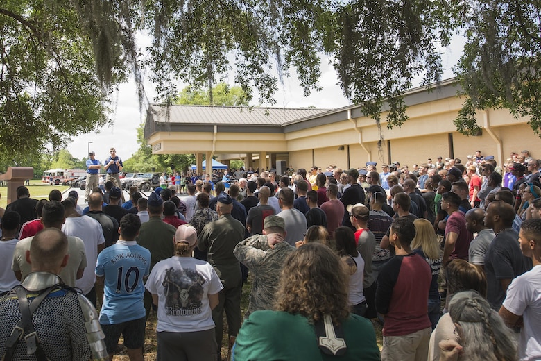 U.S. Air Force Col. Thomas Kunkel, 23d Wing commander, and Chief Master Sgt. David Kelch, 23d WG command chief, address Team Moody during Comprehensive Airmen Fitness day, April 29, 2016, at Moody Air Force Base, Ga. This CAF day focused on the social pillar by promoting Airmen to meet new people through shared interests. (U.S. Air Force photo by Airman Daniel Snider/Released)