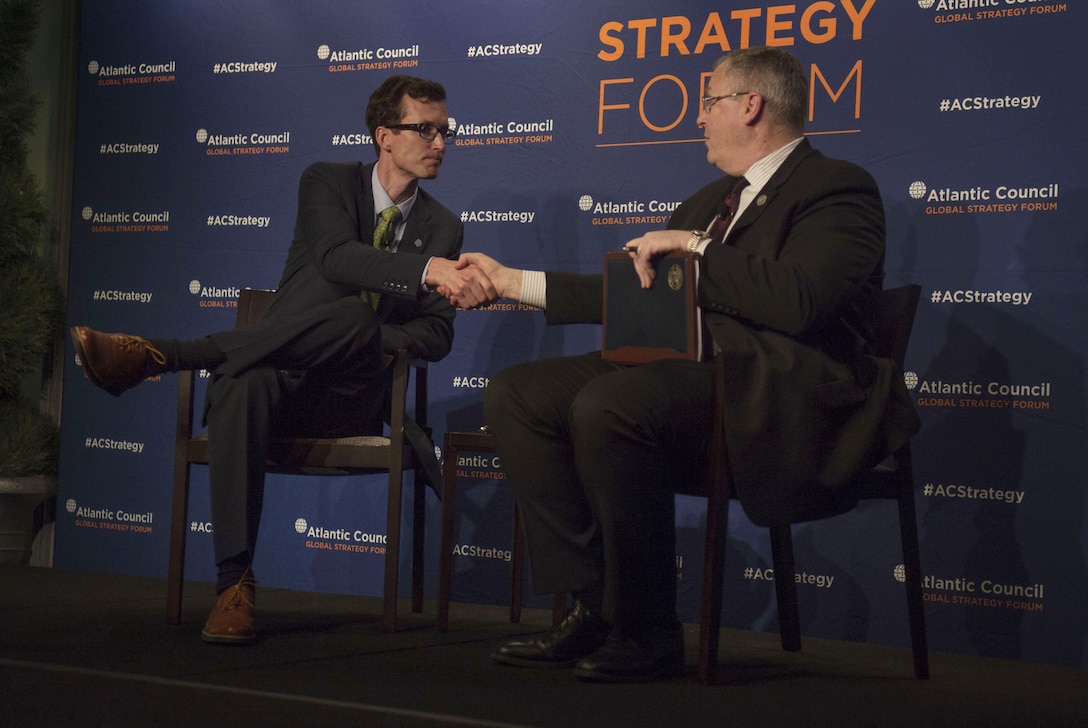 Deputy Secretary of Defense Bob Work shakes hands with moderator August Cole, Art of the Future Project director, after answering questions at the Atlantic Council's Global Strategy Forum in Washington, D.C., May 2, 2016. DoD photo by Air Force Senior Master Sgt. Adrian Cadiz