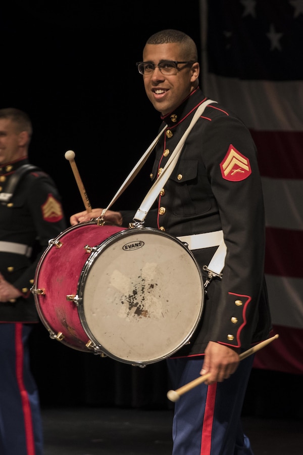 Corporal Jordan Snow, bass drummer for the Marine Corps Base Quantico band and Proctor, Vermont, native, performs with the party section of the band to a full Everett High School auditorium, March 18, 2016. The band visited the school prior to their performance in the St. Patrick's Day parade in Boston the following weekend. Snow is a Berklee College of Music graduate and travelled back and forth between Boston and Germany to eventually become a Marine Corps musician.
