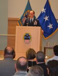 DLA Troop Support Clothing and Textiles Director Air Force Col. Patrick Owens speaks to attendees of his retirement ceremony April 22, marking the end of a 30-year military service career and his tenure at DLA. Owens’ ceremony was attended my friends, family, colleagues, fellow military officers and C&T employees.