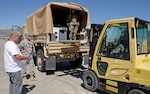 Ray Menendez (left), a DLA Disposition Services material examiner helps units at Fort Bliss, Texas, turn in excess property as part of "All Army Divestiture." Photo by Jeff Landenberger