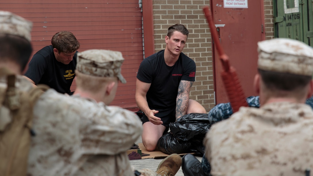 Petty Officer 1st Class Matthew J. Cool (center), a Fleet Marine Force reconnaissance corpsman and Inspector-Instructor medical staff with 4th Force Reconnaissance Company, 4th Marine Division, Marine Forces Reserve, teaches reserve sailors methods of waterproofing gear during a FMF reconnaissance corpsman screening in San Antonio, April 19, 2016. The screening was hosted by 4th Reconnaissance Battalion, 4th Marine Division, Marine Forces Reserve, for Sailors across Marine Forces Reserve and the U.S. Navy Reserve to gain familiarity with the demands of the FMF reconnaissance corpsman pipeline. 