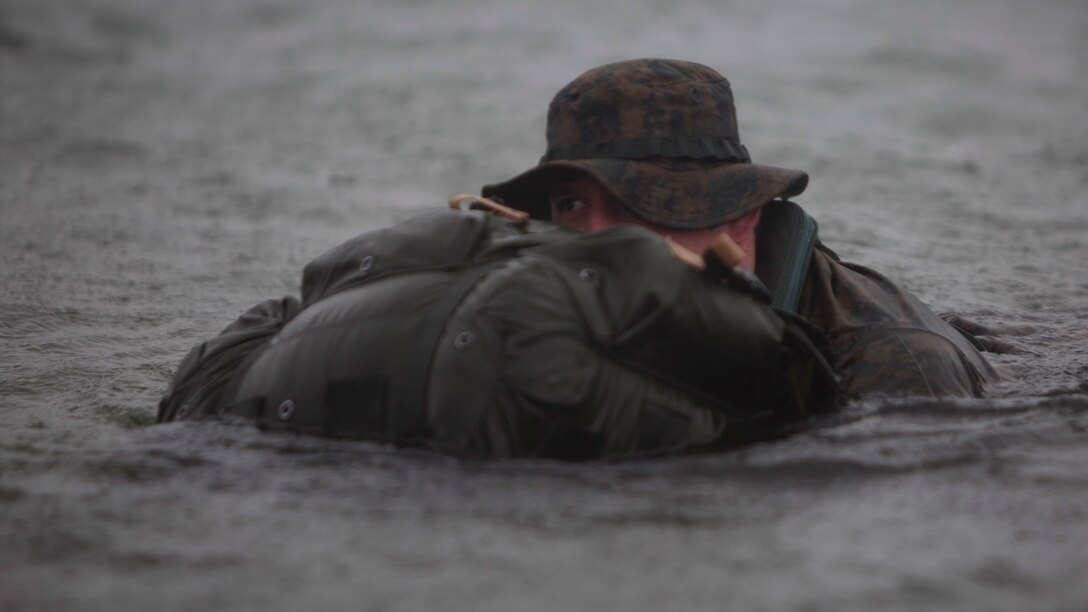 Petty Officer 3rd Class Josiah S. Gravelle, a hospital corpsman with Company E, 4th Reconnaissance Battalion, 4th Marine Division, Marine Forces Reserve finishes a 5000 meter fin swim during a Fleet Marine Force reconnaissance corpsman screening at Canyon Lake, Texas, April 21, 2016. The screening was hosted by 4th Reconnaissance Battalion for Reserve Sailors to gain familiarity with the demands of the FMF reconnaissance corpsman pipeline.