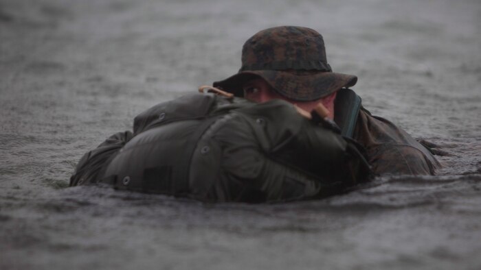 Petty Officer 3rd Class Josiah S. Gravelle, a hospital corpsman with Company E, 4th Reconnaissance Battalion, 4th Marine Division, Marine Forces Reserve finishes a 5000 meter fin swim during a Fleet Marine Force reconnaissance corpsman screening at Canyon Lake, Texas, April 21, 2016. The screening was hosted by 4th Reconnaissance Battalion for Reserve Sailors to gain familiarity with the demands of the FMF reconnaissance corpsman pipeline.