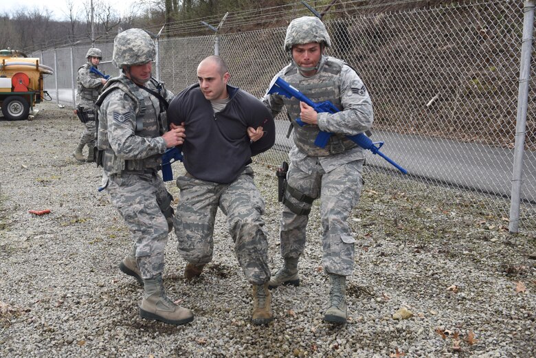 Members of the 911th Security Forces Squadron participate in a perimeter breach exercise at the Pittsburgh International Airport Air Reserve Station, April 1, 2016. The exercise was conducted over the April Academic Unit Training Assembly, a four-day training period designed to give Reserve Airmen an opportunity to update qualifications and conduct career-specific training. (U.S. Air Force Photo by Airman Bethany Feenstra)