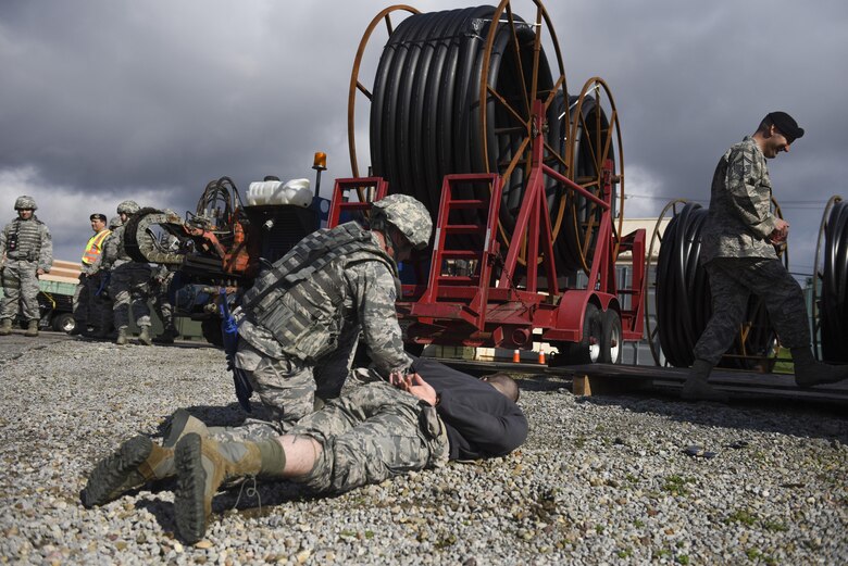 Staff Sgt. David Barbieri, fire team leader with the 911th Security Forces Squadron, restrains Staff Sgt. Domenic Mash, patrolman with the 911th SFS, as part of a perimeter breach exercise at the Pittsburgh International Airport Air Reserve Station, April 1, 2016. During the exercise Mash acted as an intruder and was successfully stopped by Barbieri and his fire team. (U.S. Air Force Photo by Airman Bethany Feenstra)