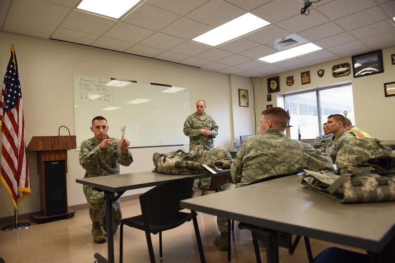 Tech. Sgt. Wenger, training manager with the 911th Security Forces Squadron debriefs his team after they participated in a perimeter breach exercise at the Pittsburgh International Airport Air Reserve Station, April 1, 2016. The exercise was part of the career specific training part of the base’s Academic Unit Training Assembly, a training weekend dedicated to keeping Airmen qualified year round. (U.S. Air Force Photo by Airman Bethany Feenstra)