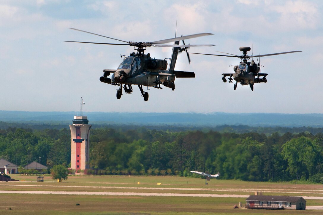 AH-64D Apache helicopters fly by the air traffic control tower while departing McEntire Joint National Guard Base in Eastover, S.C., April 23, 2016, to participate in gunnery qualifications and annual training at Fort Stewart, Ga. South Carolina Army National Guard photo by Staff Sgt. Roberto Di Giovine