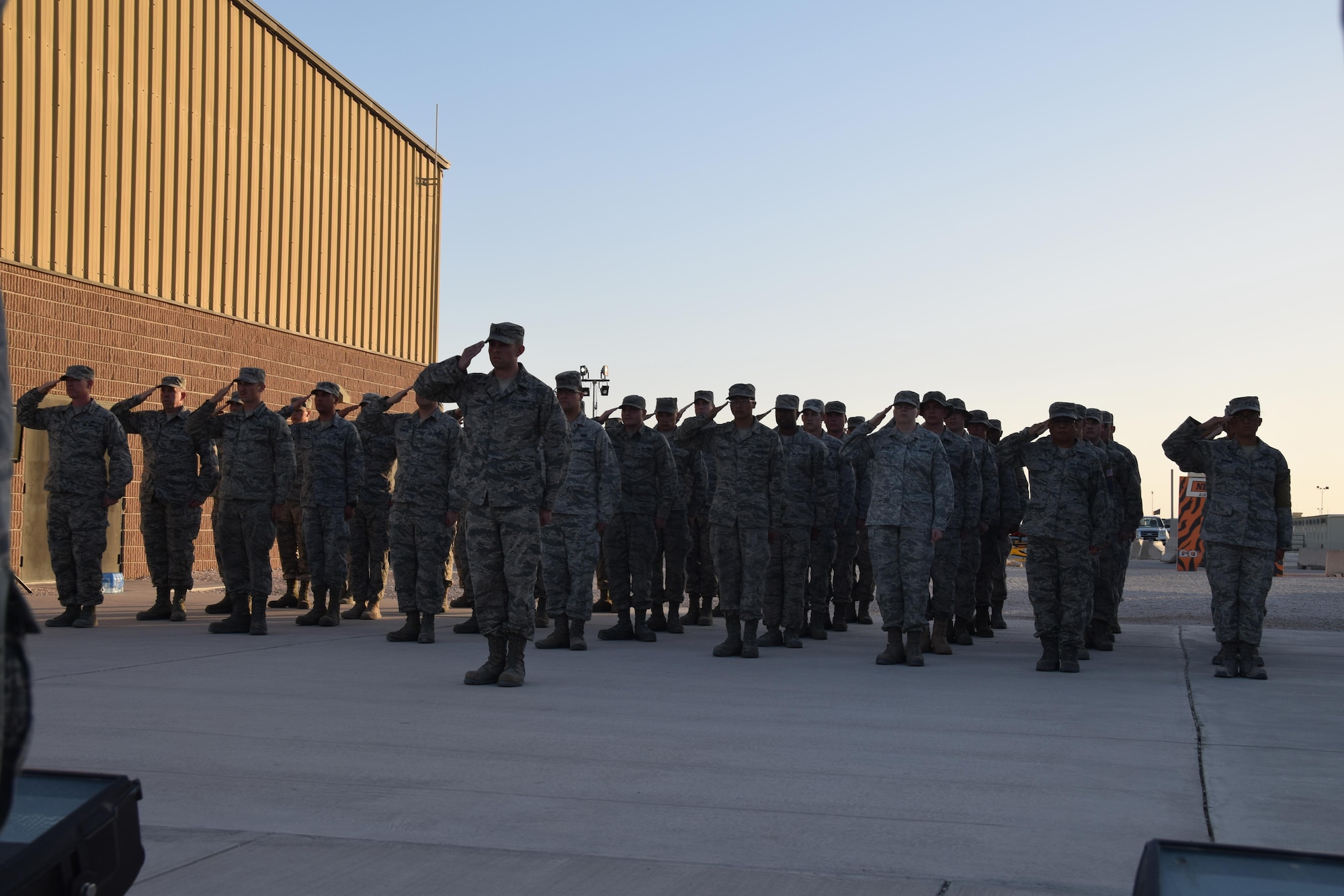 Military members from the 379th Air Expeditionary Wing render honors May 1, 2016, at a retreat ceremony honoring the “Days of Remembrance” observance at Al Udeid Air Base, Qatar.  The week-long observance honors the memory of victims who were killed in the Holocaust. (U.S.  Air Force photo by Technical Sgt. Carlos J. Trevino/Released)