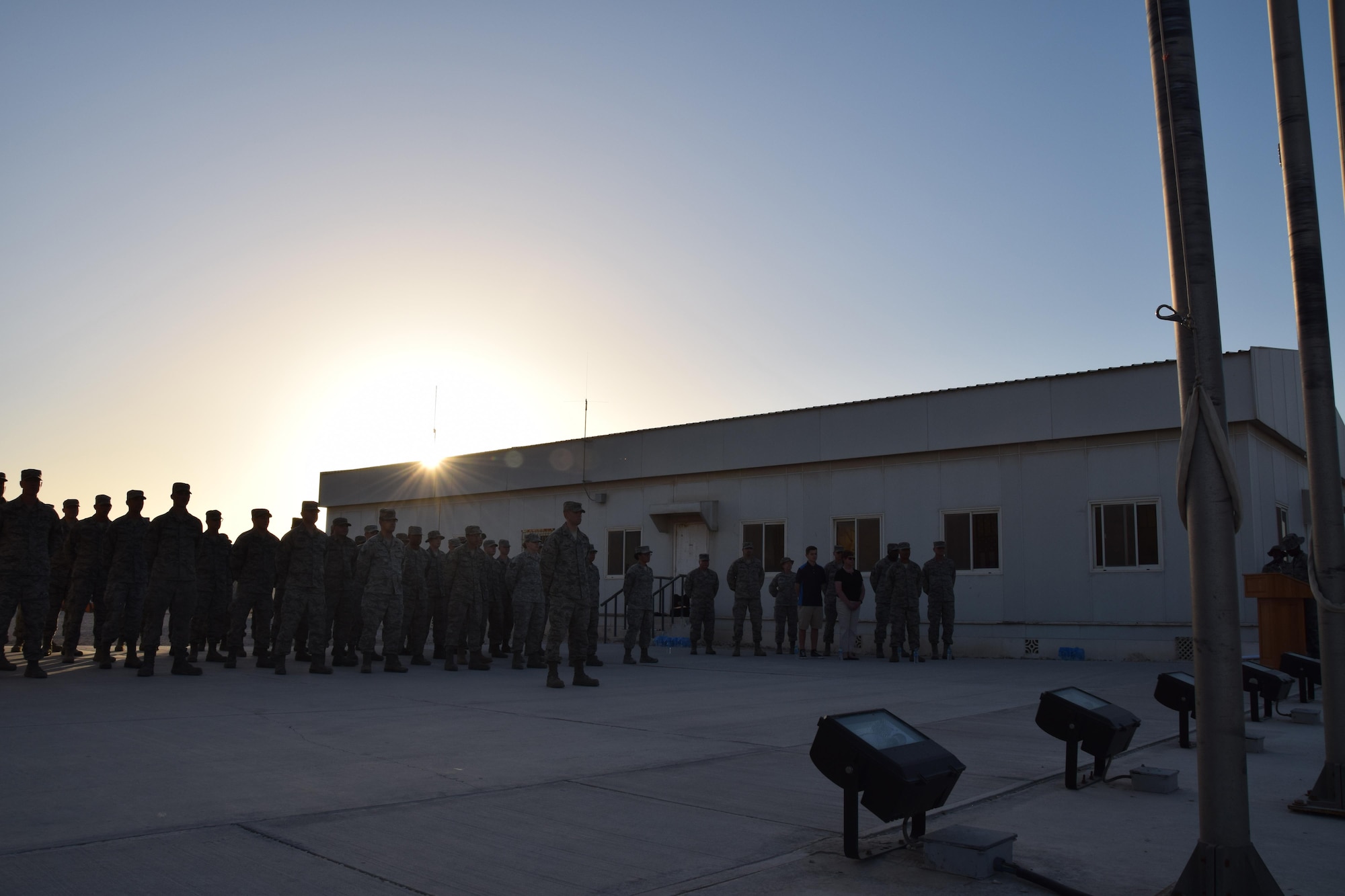 Military members from the 379th Air Expeditionary Wing assume the position of parade rest May 1, 2016, prior to the beginning of a retreat ceremony to commemorate the “Days of Remembrance” at Al Udeid Air Base, Qatar.  The week-long observance honors the memory of victims who were killed in the Holocaust. (U.S.  Air Force photo by Technical Sgt. Carlos J. Trevino/Released)