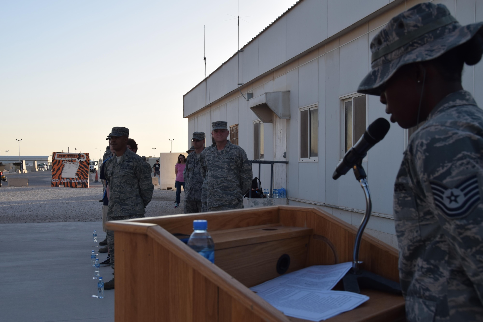 Tech. Sgt. Ashunta Taylor, 379th Air Expeditionary Wing staff, emcees the retreat ceremony to open the “Days of Remembrance” observance May 1, 2016, at Al Udeid Air Base, Qatar.   The event honors the memory of Holocaust victims during World War II. (U.S.  Air Force photo by Technical Sgt. Carlos J. Trevino/Released)