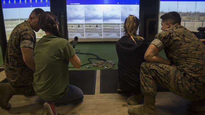 Marines with II Marine Headquarters Group show their spouses how to operate the M4 Assault Rifle during II MHG’s: “In Their Boots Day” at Camp Lejeune, N.C., April 29, 2016. The spouses and family members spent a few hours at the Indoor Simulated Marksmanship Trainer getting the opportunity to safely operate the different weapons systems that the Marine Corps uses. (U.S. Marine Corps photo by Cpl. Justin T. Updegraff/ Released)