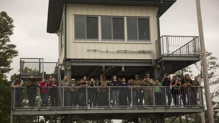 Observing from a safe distance, family members and spouses observe the operation of the M240 Bravo Light-Machine Gun and the .50 Caliber Machine Gun during II Marine Headquarters Group’s: “In Their Boots Day” aboard Camp Lejeune, N.C., April 29, 2016. The Marines also demonstrated talking guns, utilizing two M240s and a .50 Caliber Machine Gun. (U.S. Marine Corps photo by Cpl. Justin T. Updegraff/ Released)