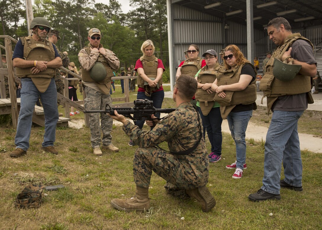 A U.S. Marine with II Marine Headquarters Group goes over the course of fire with the spouses and family members during II MHG’s: “In Their Boots Day” aboard Camp Lejeune, N.C., April 29, 2016. During the course of fire, they shot in the standing, kneeling and prone position and received any needed corrections from the Marine assigned to them. (U.S. Marine Corps photo by Cpl. Justin T. Updegraff/ Released)