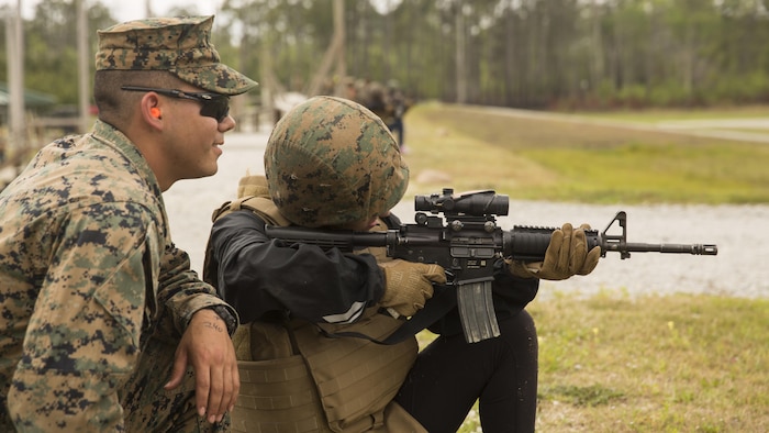 Olivia Shane, a spouse, accurately shoots the target from the kneeling during II Marine Headquarters Group’s: “In Their Boots Day” aboard Camp Lejeune, N.C., April 29, 2016. During the course of fire, they shot in the standing, kneeling and prone position and received any needed corrections from the Marine assigned to them. (U.S. Marine Corps photo by Cpl. Justin T. Updegraff/ Released)