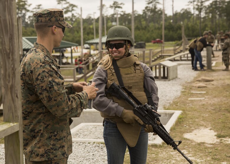 Jill Lane, a spouse, receives positives comments after completing the course of fire during II Marine Headquarters Group’s: “In Their Boots Day” aboard Camp Lejeune, N.C., April 29, 2016. During the course of fire, they shot in the standing, kneeling and prone position and received any needed corrections from the Marine assigned to them. (U.S. Marine Corps photo by Cpl. Justin T. Updegraff/ Released)