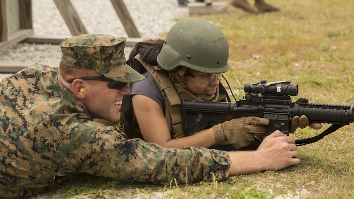 Yazmine Thomas, a spouse, receives from tips from Lance Cpl. Connor Parks, a water support tech with II Marine Headquarters Group during II MHG’s: “In Their Boots Day” aboard Camp Lejeune, N.C., April 29, 2016. During the course of fire, they shot in the standing, kneeling and prone position and received any needed corrections from the Marine assigned to them. (U.S. Marine Corps photo by Cpl. Justin T. Updegraff/ Released)