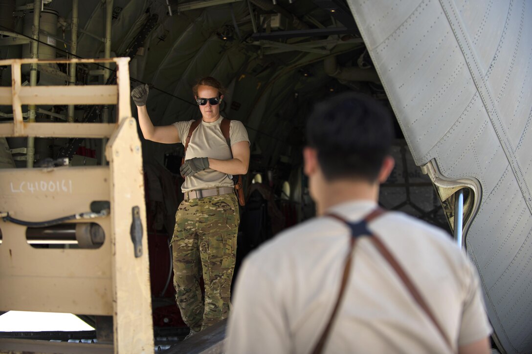 Air Force Senior Airman Jessica Jones, left, directs a forklift to lower cargo onto the ramp of a C-130J Super Hercules aircraft at Bagram Airfield, Afghanistan, April 29, 2016. Jones is a loadmaster assigned to the 774th Expeditionary Airlift Squadron. Aircraft loadmasters are responsible for loading, securing and escorting cargo and passengers; and ensuring the plane is properly balanced with the weight of the cargo evenly distributed. Air Force photo by Senior Airman Justyn M. Freeman