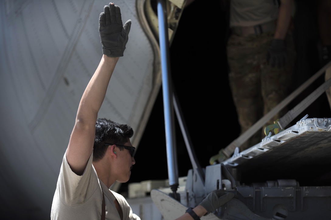 Air Force Senior Airman Chris Arnold directs a forklift carrying cargo for loading into a C-130J Super Hercules aircraft at Bagram Airfield, Afghanistan, April 29, 2016. Arnold is a loadmaster assigned to the 774th Expeditionary Airlift Squadron. Air Force photo by Senior Airman Justyn M. Freeman