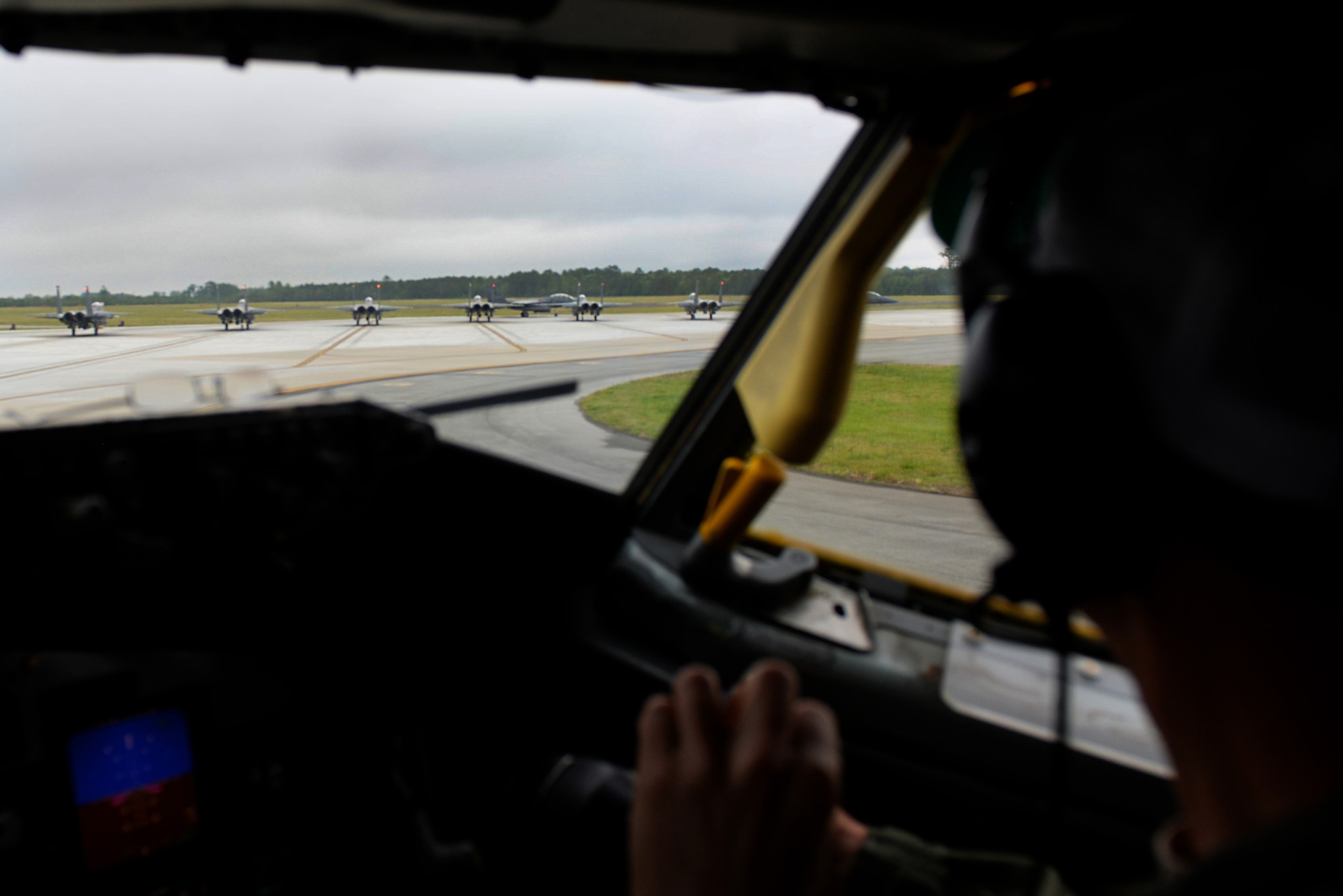 Lt. Col. Matt Young, 77th Air Refueling Squadron pilot, observes F-15E Strike Eagle aircraft preparing to take off, April 27, 2016, at Seymour Johnson Air Force Base, North Carolina. Young and Capt. Grant Fountain, also a 77th Air Refueling Squadron pilot, flew a KC-135R Stratotanker which accompanied the F-15Es halfway to Hill Air Force Base, Utah to participate in exercise Combat Hammer. (U.S. Air Force photo by Senior Airman Patrick Cole/Released) 