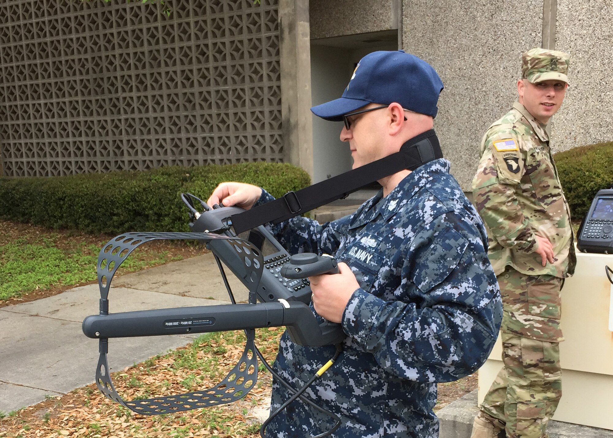 Information Systems Technician 1st Class Michael Phillips, a staff member at Center for Information Dominance (CID) Keesler Air Force Base, practices with the Rohde & Schwarz Portable Receiver 100 (PR100), under Sgt. 1st Class Timothy Kowalski's guidance. The PR100 is a state-of-the-art tool used by spectrum managers worldwide to find sources of interference and is replacing an older model spectrum analyzer taught in CID Keesler's Spectrum Operations Apprenticeship Course. (U.S. Air Force photo by Tech. Sgt. Jason Stover, 333rd Training Squadron)