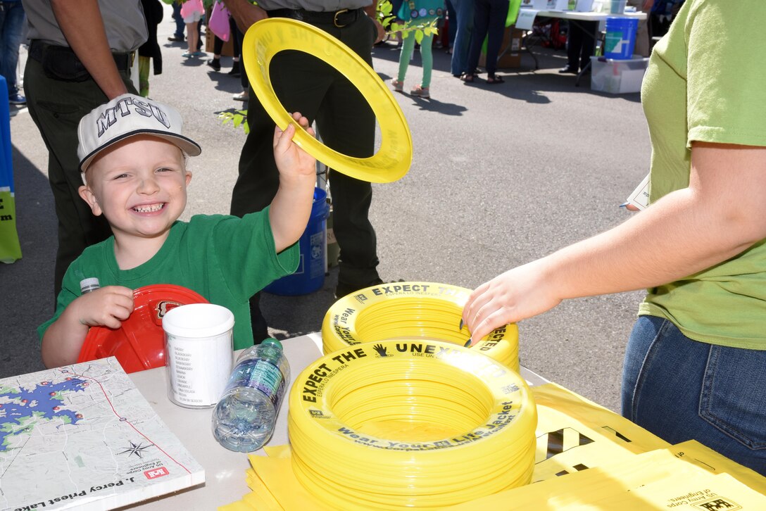 This young lad is very happy to receive a water safety frisbee at the U.S. Army Corps of Engineers Nashville District booth during Earth Day festivities at Town Square in Murfreesboro, Tenn., April 23, 2016. (USACE photo by Leon Roberts)