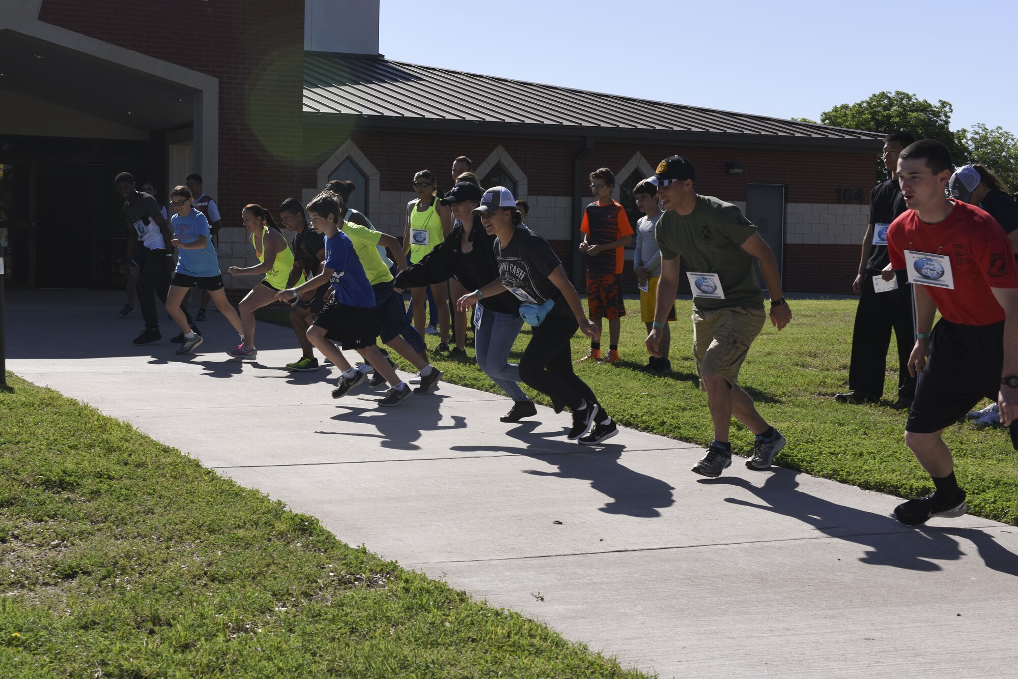 Participants of the 6th annual Sexual Assault Response Coordinator Challenge sprint for the first objective at the Taylor Chapel on Goodfellow Air Force Base, Texas, April 30, 2016. The challenge raised awareness of Sexual Assault Prevention and Response through engaging participants in games and riddles. (U.S. Air Force photo by Airman 1st Class Chase Sousa/Released)
