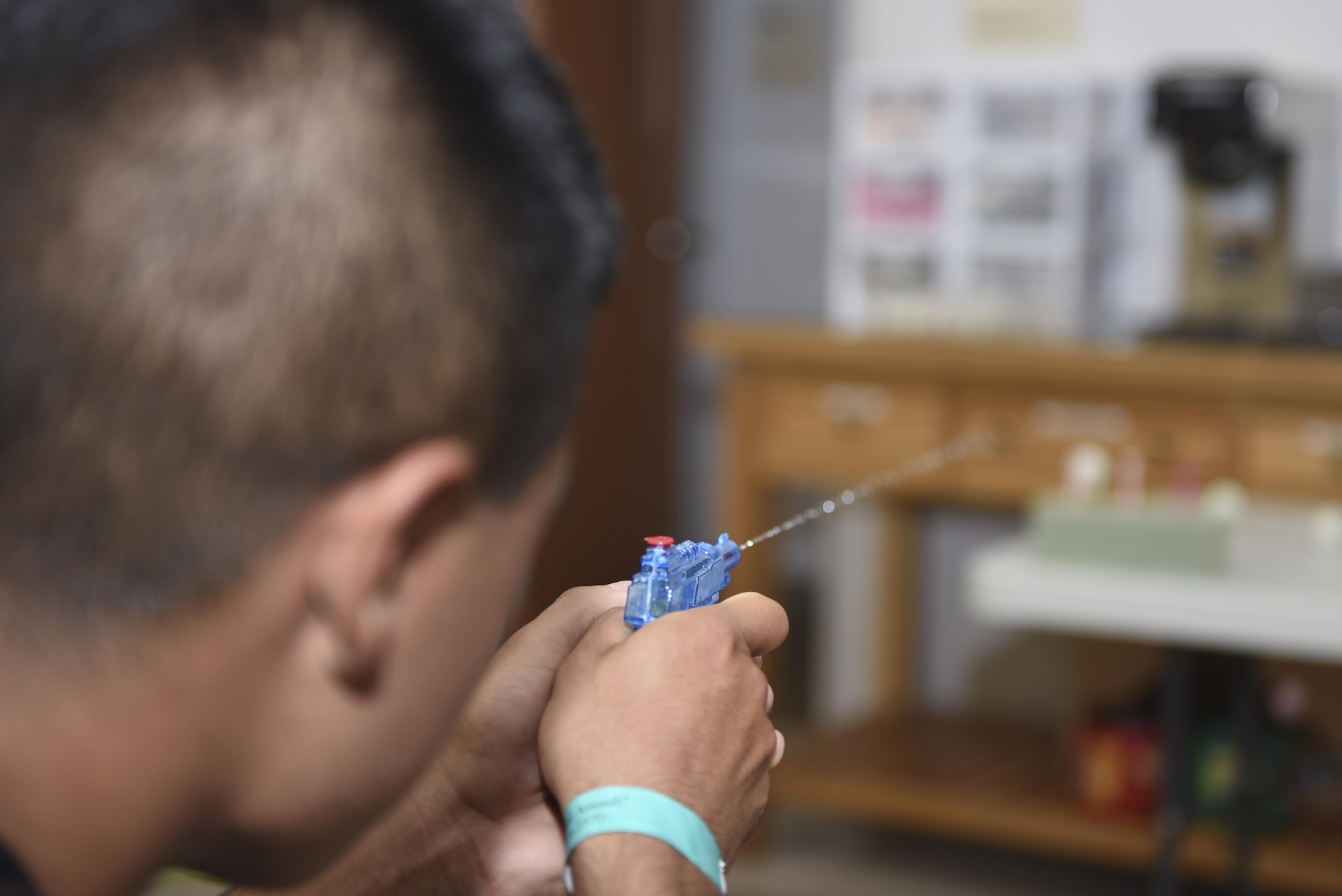 A sixth annual Sexual Assault Response Coordinator Challenge participant attempts to shoot ping pong balls off of a golf tee at the Taylor Chapel on Goodfellow Air Force Base, Texas, April 30, 2016. After all competitors finished, the winning team was announced at Taylor Chapel. (U.S. Air Force photo by Airman 1st Class Chase Sousa/Released)