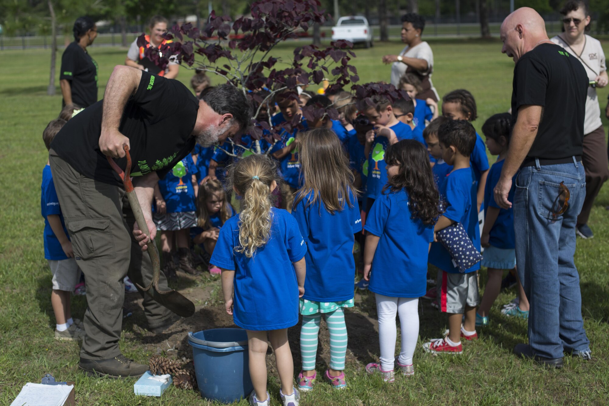 John Crain, 23d Civil Engineer Squadron forester, shovels dirt around the base of a tree during an Arbor Day ceremony, April 28, 2016, at Moody Air Force Base, Ga. The ceremony taught children about the importance of trees and offered them an opportunity to help plant one. (U.S. Air Force photo by Airman Daniel Snider/Released)